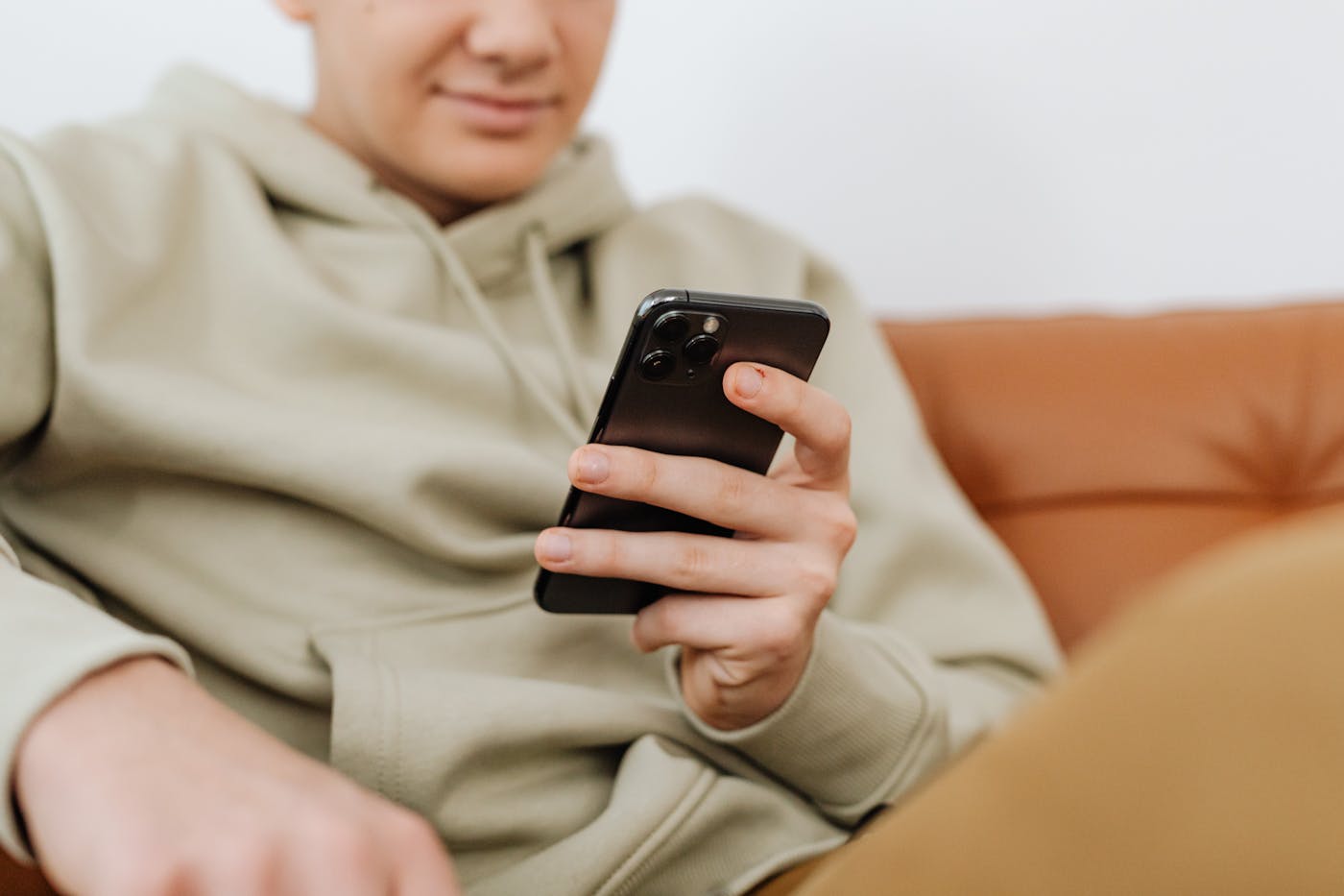A person using a phone while sitting on a couch